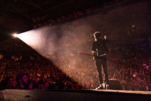 An artiste performing to a crowd as a way of pushing in his music career.